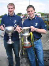 Dave Gilmartin of Salthill Knocknacarra and Corinthians holding the Andy Merrigan Cup and Ciaran Dunne of Corinthians comparing Silverware